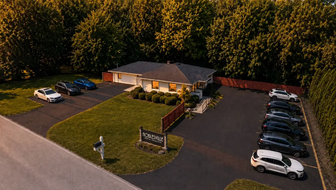 Aerial view of the Noblesville Dental Associates office on River Road at golden hour